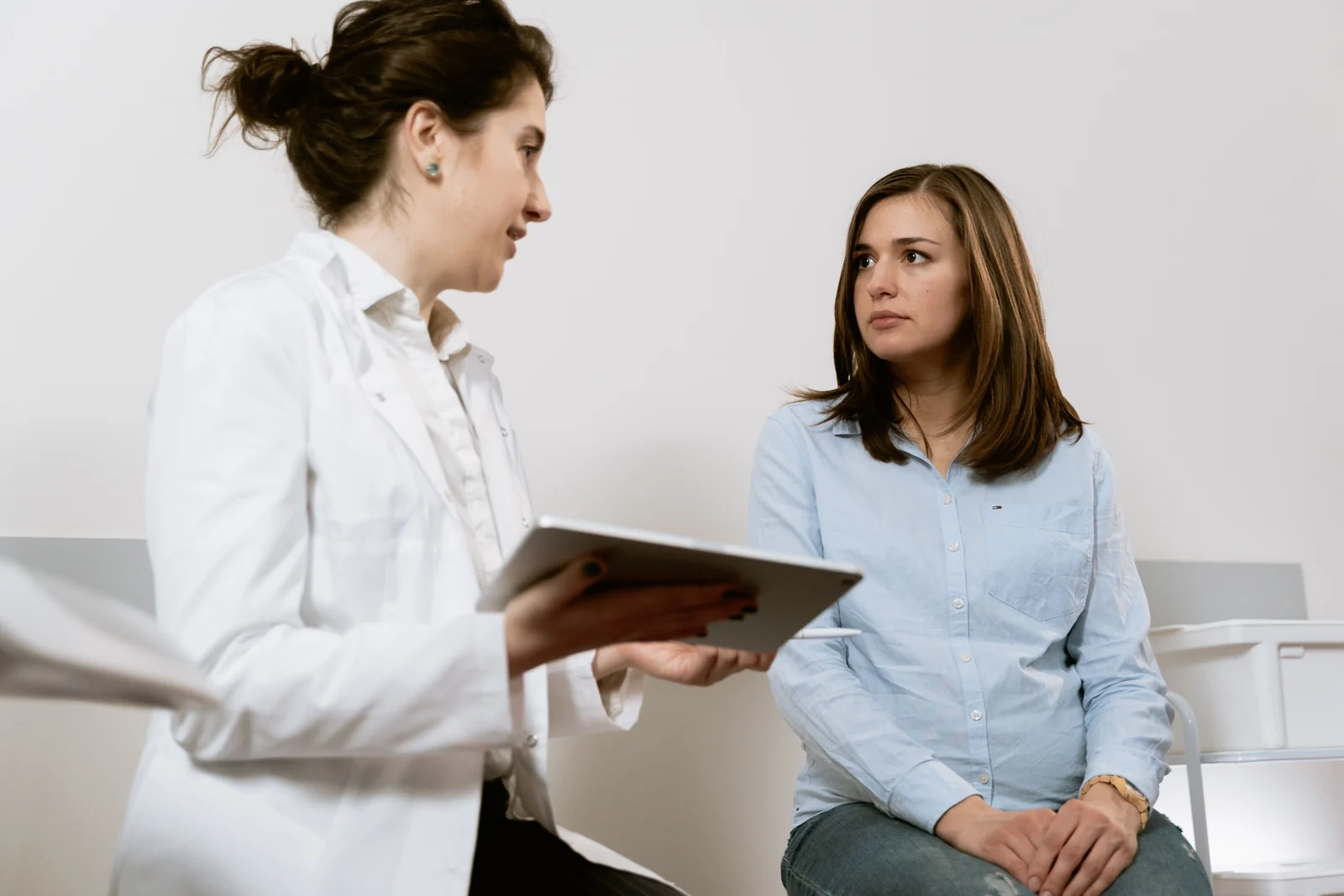 A woman discussing care with a female clinician